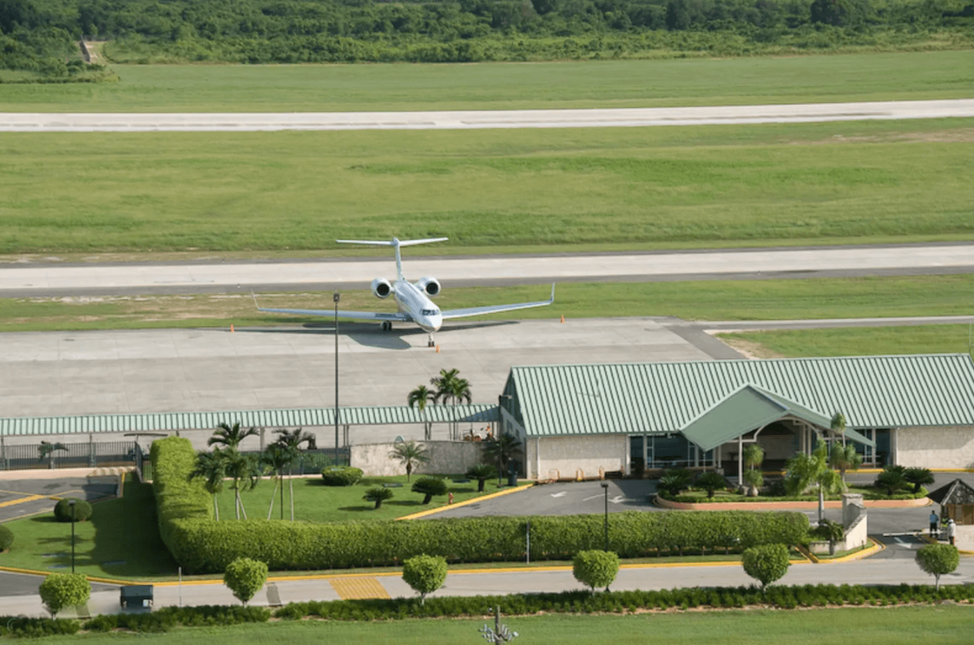 Aerial view of a private jet on the runway beside the terminal at La Romana International Airport