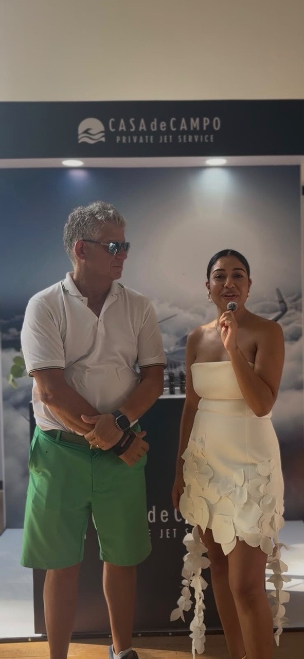 Mr. Zuckerman and Vanesa Cueto speaking in front of the Casa de Campo Private Jet Service booth